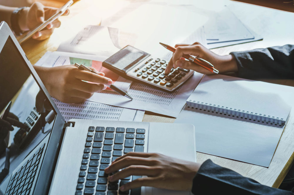 Two business people calculating mortgage fees